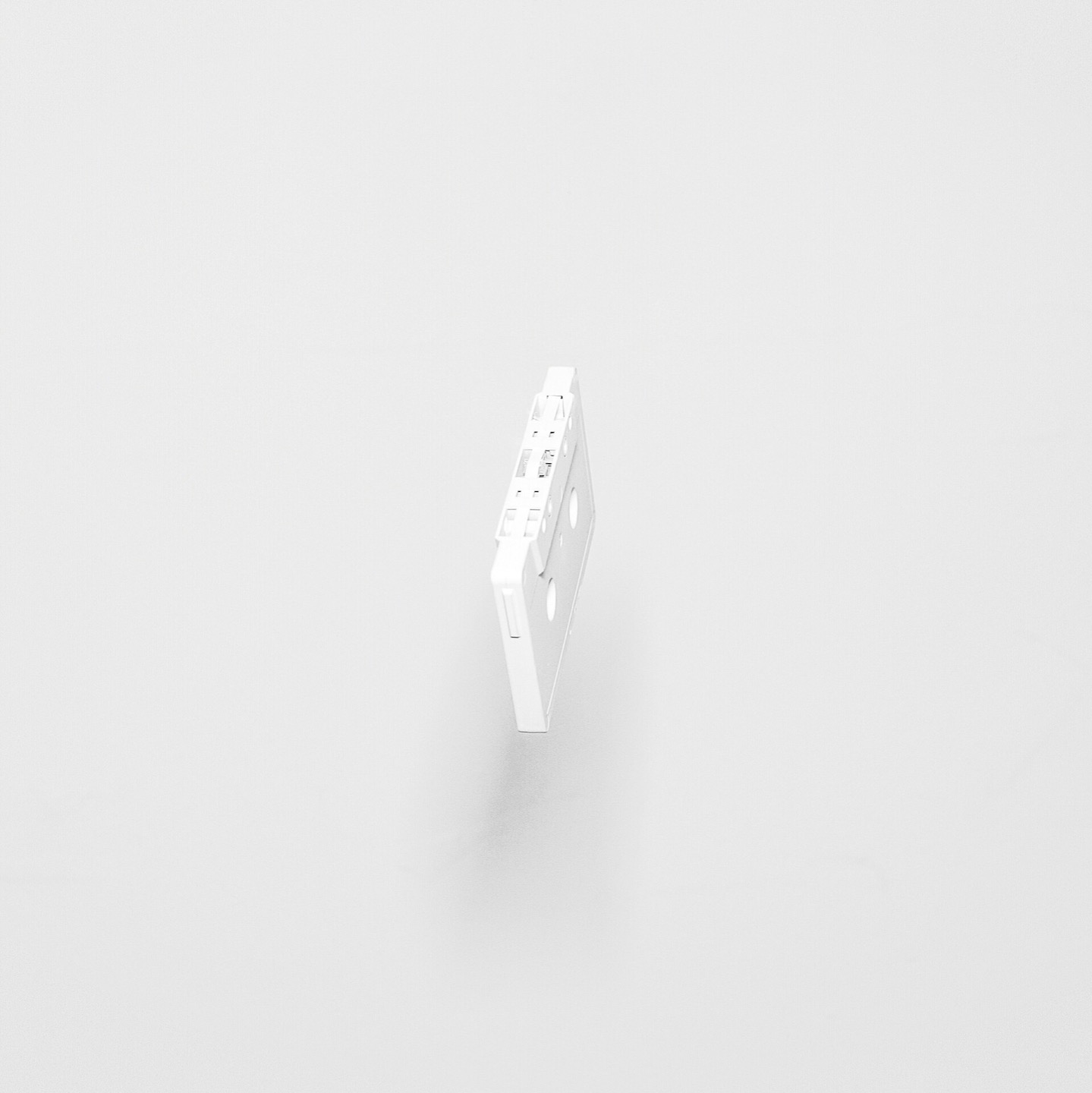 White compact cassette on a white background
